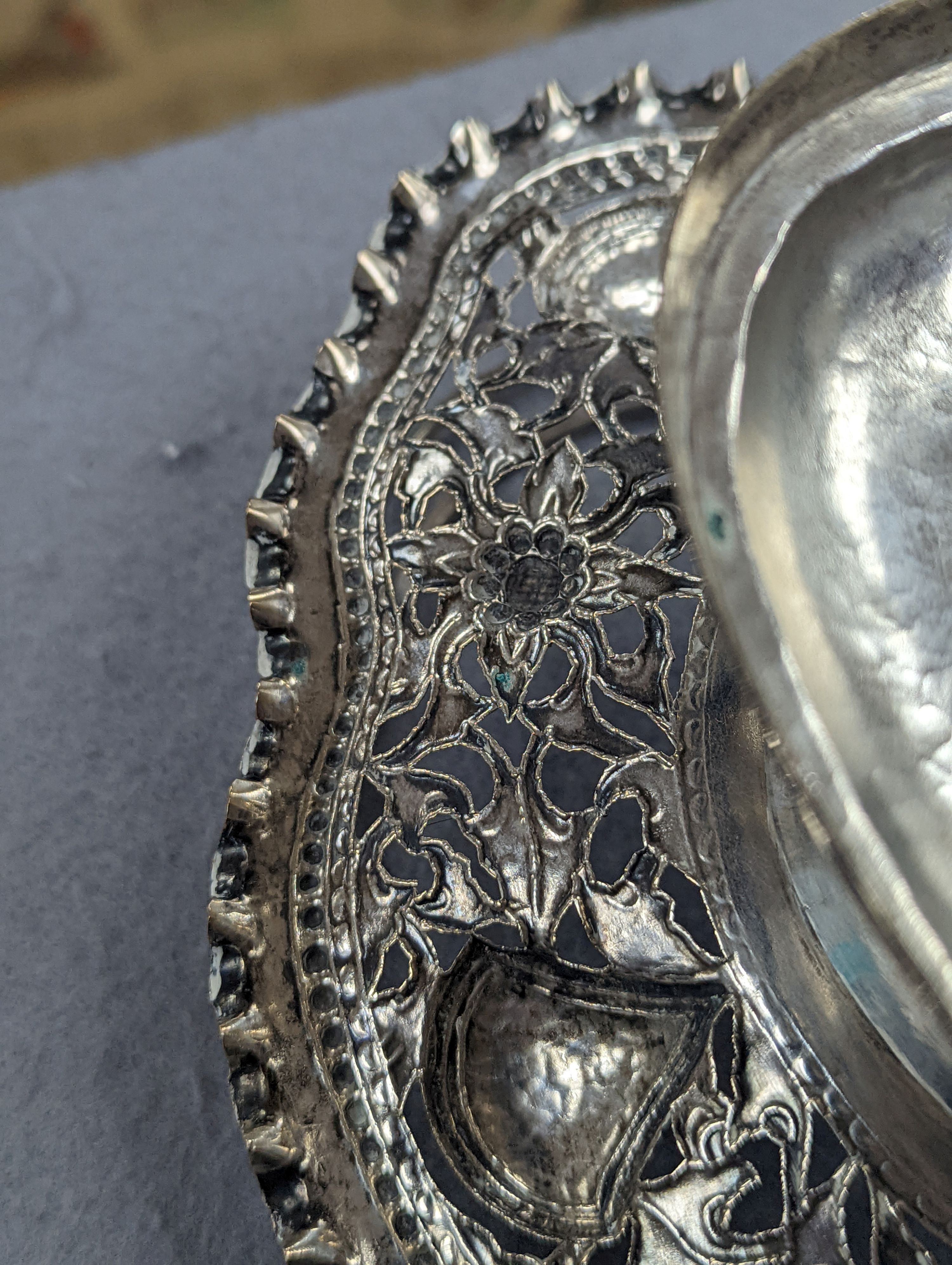 A Chinese pierced and embossed white metal shaped oval pedestal basket, length 21.6cm, 9oz, signed on base.